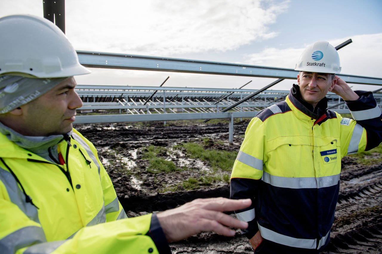 Black and white picture of placing solar panels in ominous weather